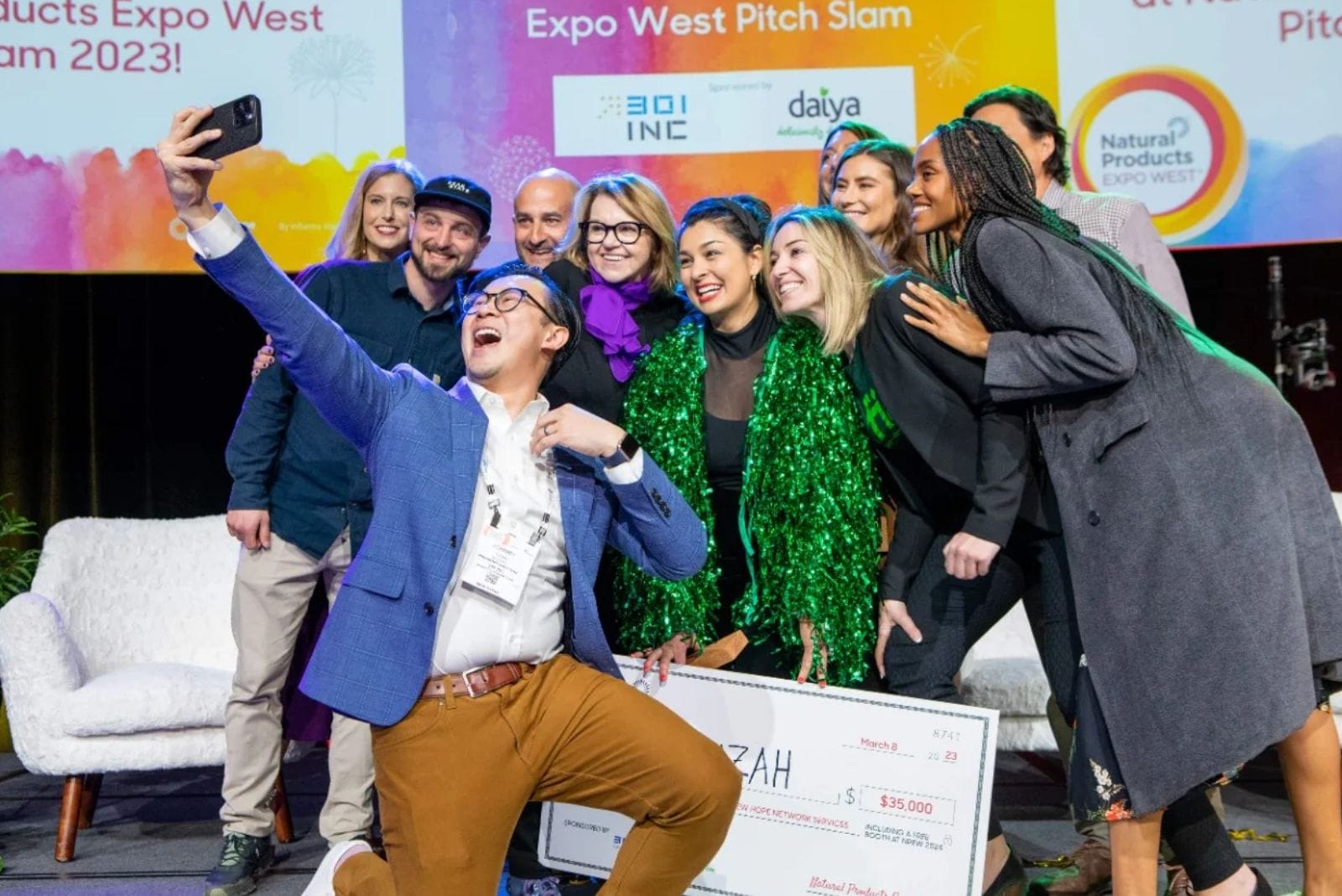 Group of people take selfie during Natural Products Expo West Pitch Slam 2023