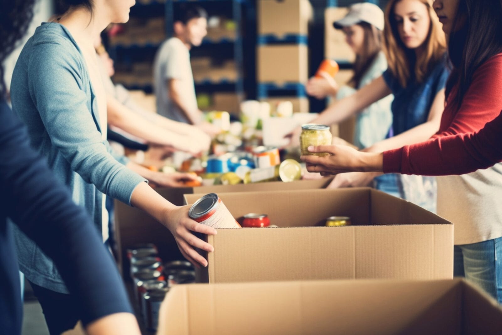 Volunteers sorting canned goods at a community food bank