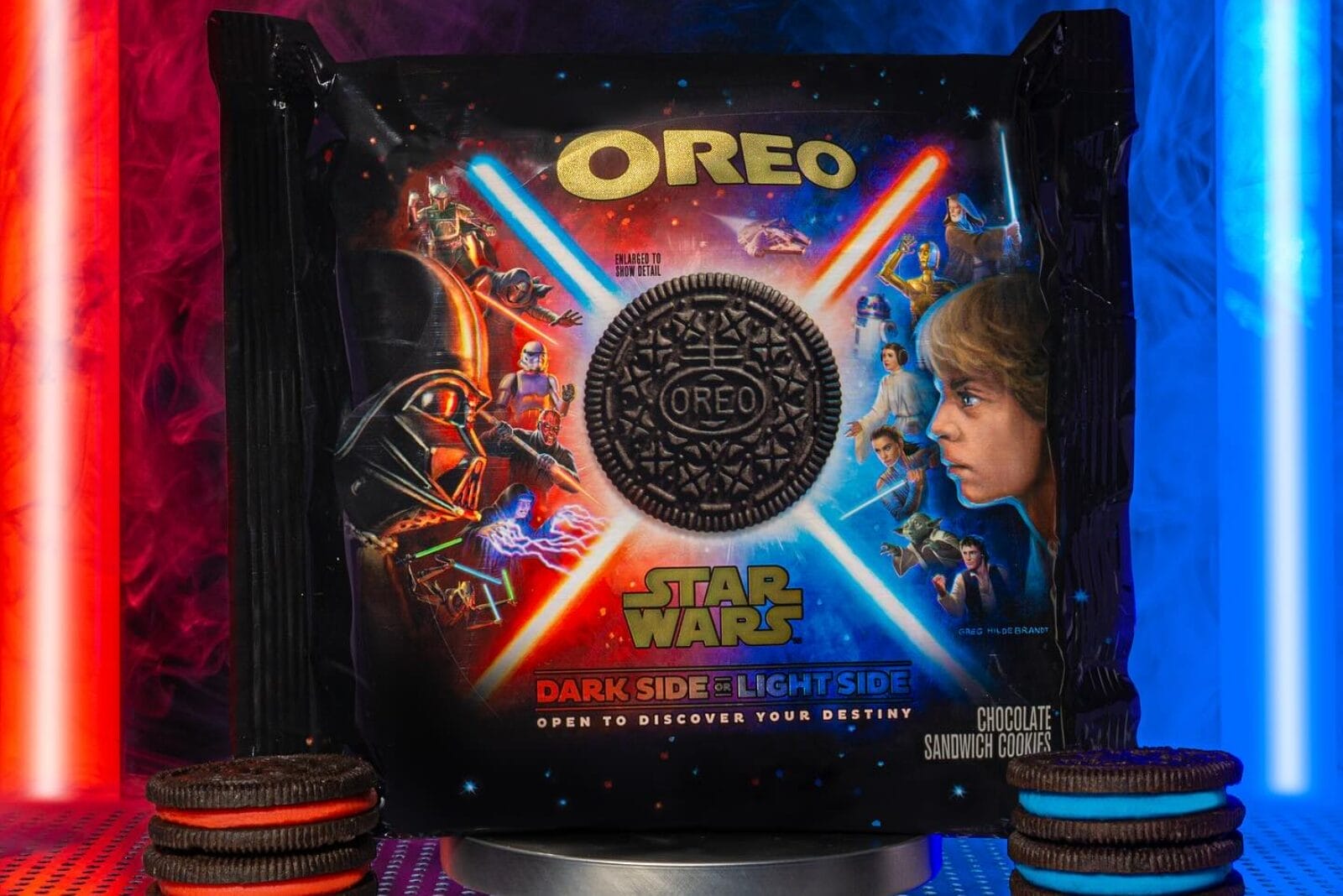Package of Star Wars-themed OREOs next to lightsabers.