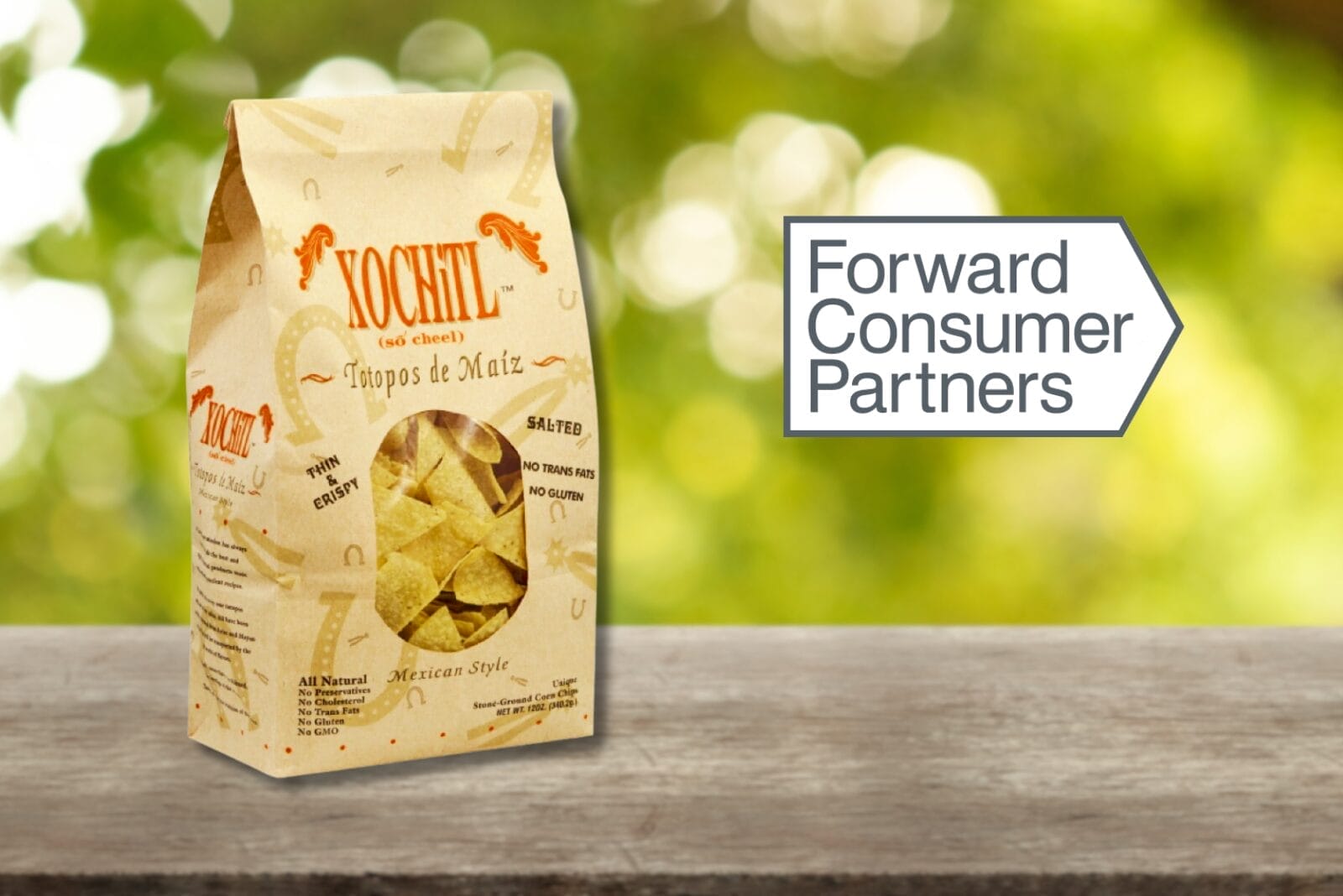 Bag of Xochitl tortilla chips on picnic table background with Forward Consumer Partners logo.