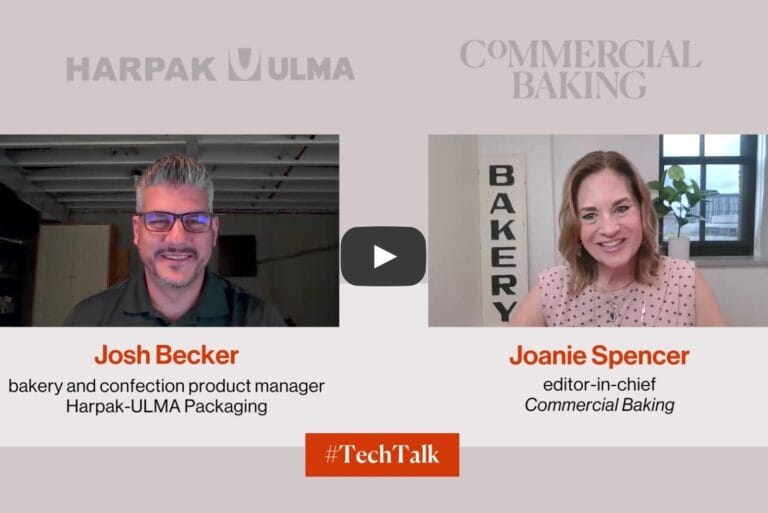 Two people discussing AI-enabled packaging applications from Harpak-ULMA Packaging.