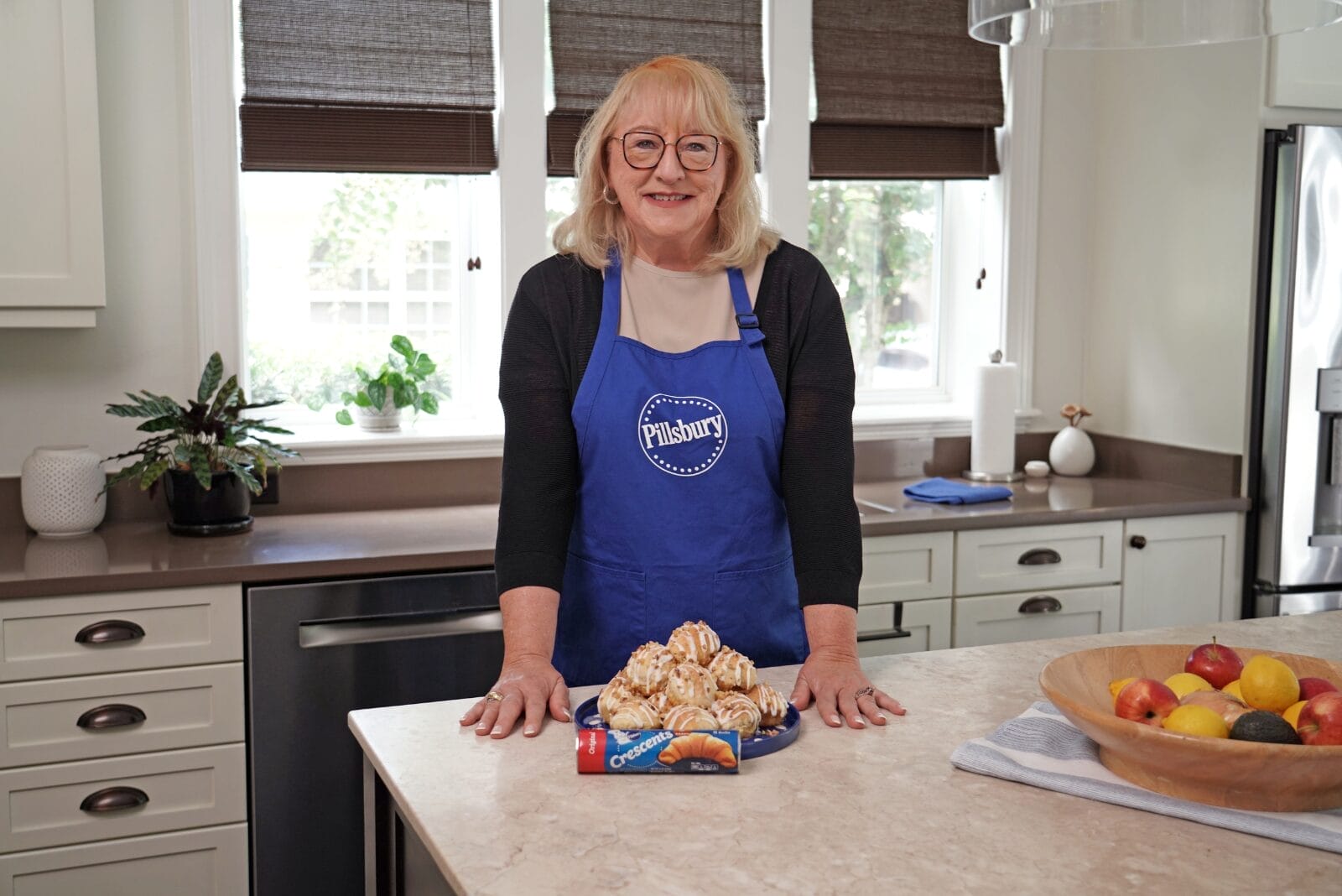 Donna Kelce in the kitchen with a plate full of croissants.