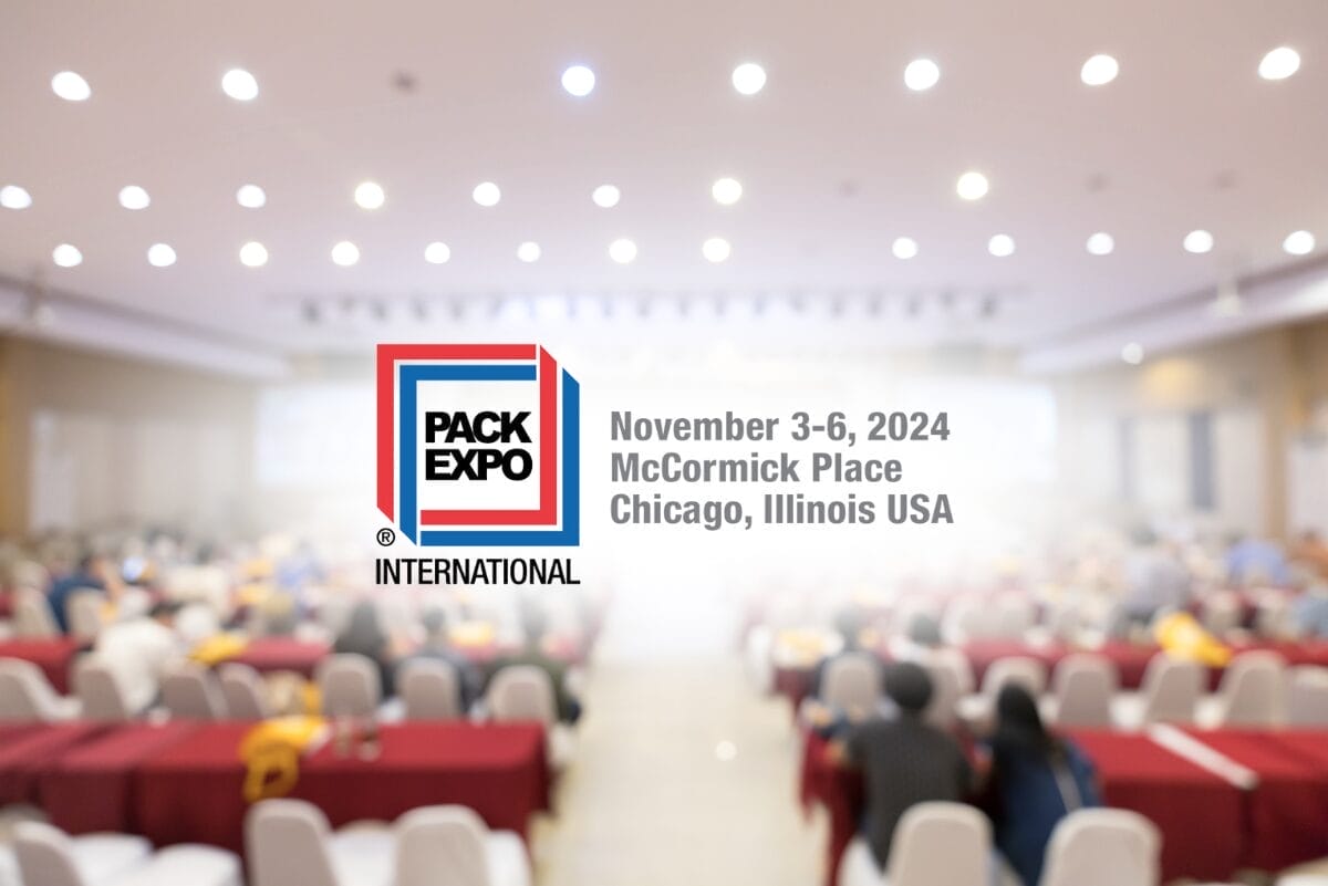 Pack Expo logo on blurred background of people attending a seminar.