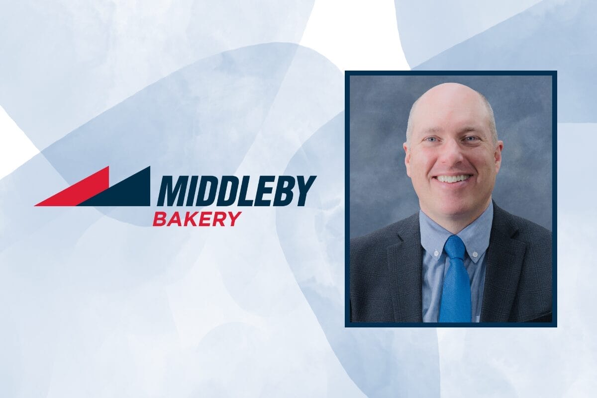 Middleby Bakery logo next to Mike Scouten, wearing a blue tie, light blue shirt and black blazer, on blue background