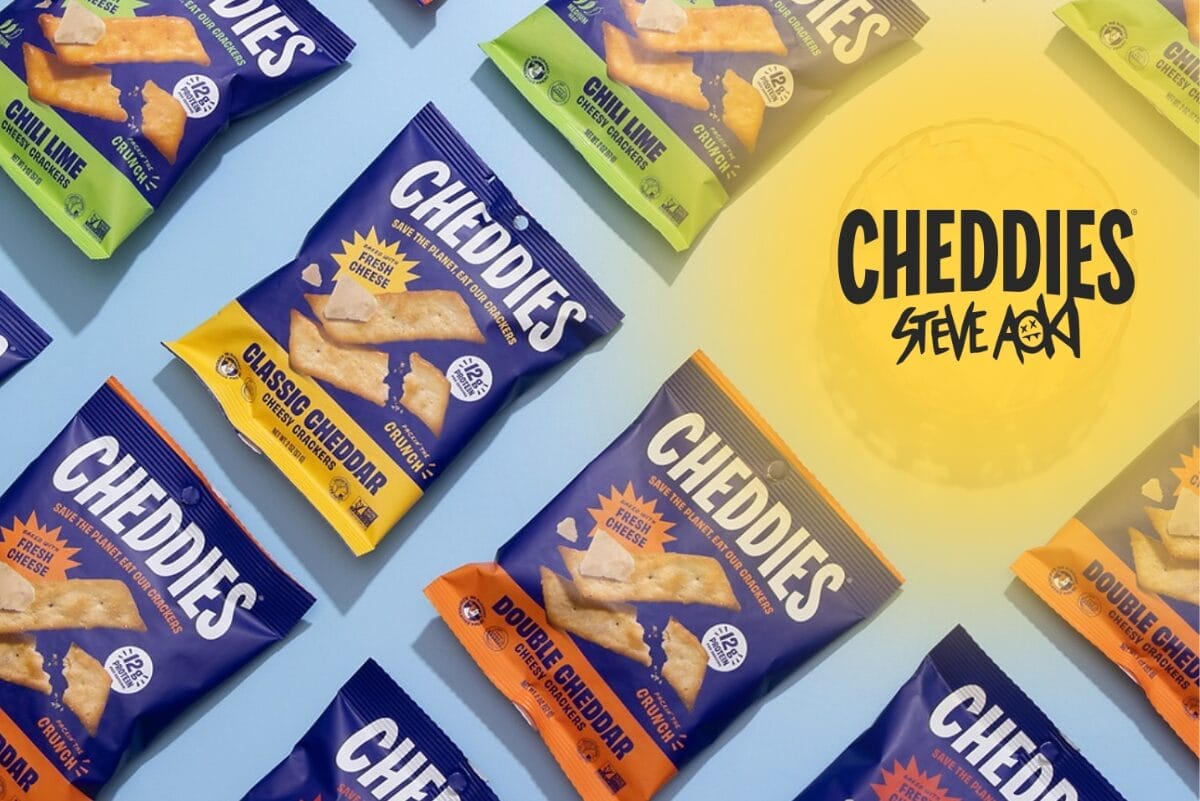 Packs of Cheddies on light blue background with Cheddies Steve Aoki logo in upper right corner