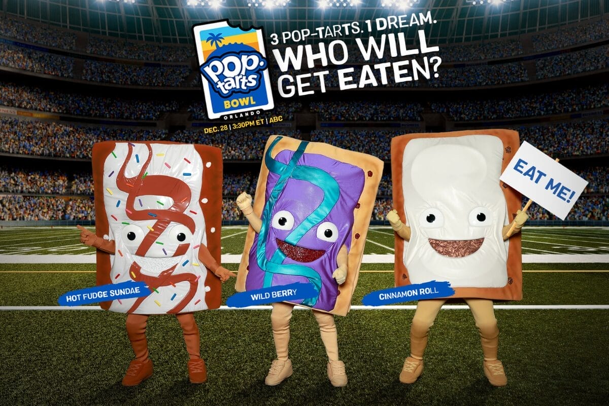 Three Edible Mascots standing in a stadium.