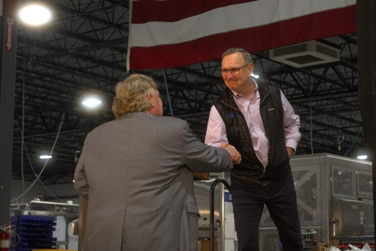 Craig Souser, president and CEO of JLS, shaking hands with person