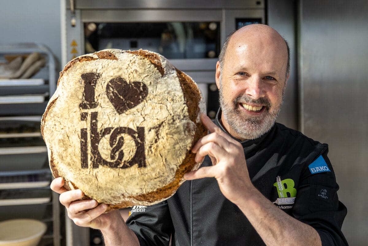 Man holding bread that says I love iba