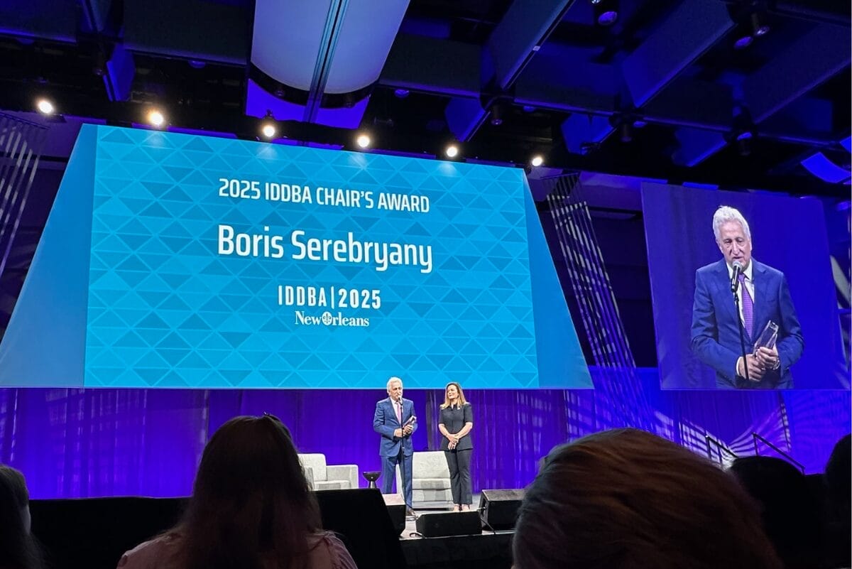 Boris Serebryany, CEO and president of Fiera Foods, with Carmela Serebryany, IDDAB chair, accepting Chair's Award during IDDBA 2025