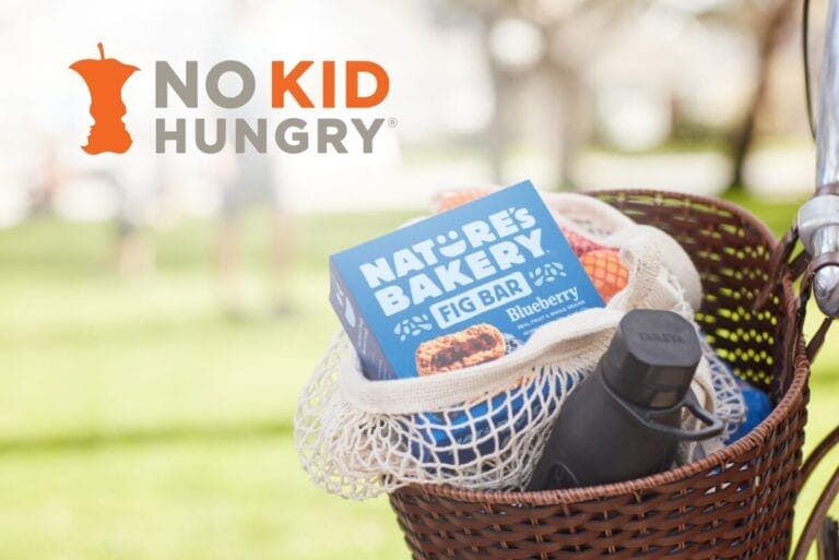No Kid Hungry in top left corner of image with Nature's Bakery box in basket of bicycle